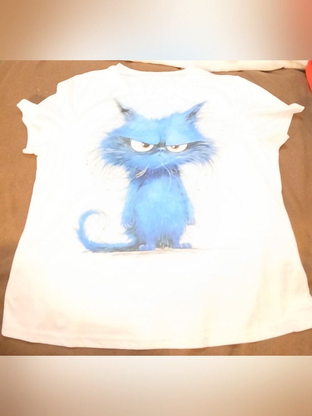 NWOT White T-Shirt with Blue Cartoon Cat Graphic.
